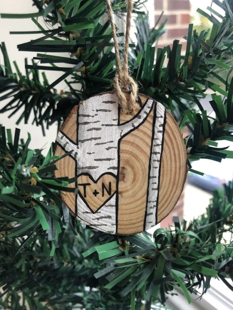 Hand painted rustic wood slice Christmas ornament featuring a personalized birch tree. Perfect for newlyweds, engaged couples or long term married couples for a personal, thoughtful gift.